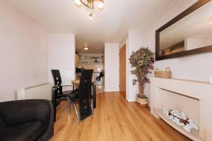 a living room with a couch and a fireplace at Chic & Radiant 1BD Flat near Dublin City Centre! in Dublin