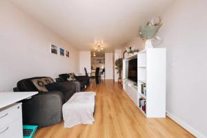 a living room with a couch and a tv at Chic & Radiant 1BD Flat near Dublin City Centre! in Dublin