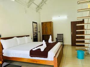 a bedroom with a bed with two towels on it at Brooke Forest Heaven Resort in Vythiri