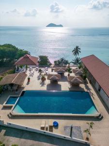 an aerial view of a resort with a swimming pool and the ocean at Baan Jai Dee Beach Front Hotel in Wok Tum
