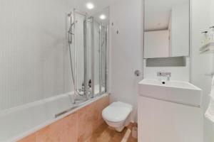 a bathroom with a toilet and a sink and a shower at Best Mayfair Location with 2 Super King Beds in London