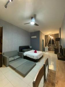 a bedroom with a bed and a couch in it at 5mins to Sunway Pyramid #Subang SS15 Cozy studio in Subang Jaya
