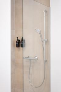 a shower in a bathroom with a glass door at Vienna Heights Premium Apartments in Vienna