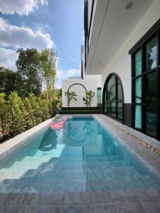 a swimming pool in the backyard of a house at Baan Khongkwan Pool villa Khaoyai Pakchong in Pak Chong +23 photos