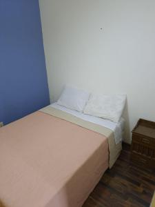 a small bedroom with a bed and a night stand at Daymán Apart Hotel in Termas del Daymán