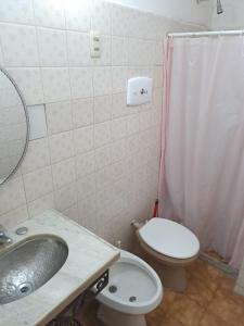 a bathroom with a sink and a toilet and a shower at Daymán Apart Hotel in Termas del Daymán