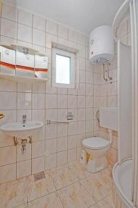 een badkamer met een toilet en een wastafel bij Apartments Ivan in Novalja
