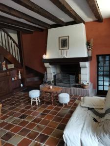 a living room with a fireplace and a table at La planque de l'éclusier in Castelnau-de-Lévis