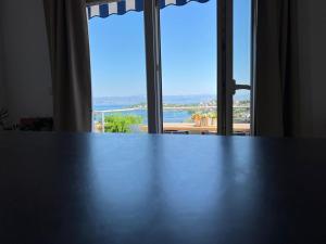 a table in front of a window with a view at Apartman I & R in Nečujam