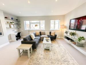 a living room with a couch and a table at 3-Bedroom Flat with FREE parking in the Heart of Hampton Hill Village in Hampton Hill