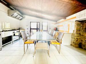 a dining room with a glass table and chairs at Casa Paloma Private Villa in Cicerale