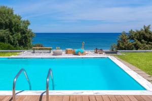 a swimming pool with a view of the ocean at Villa Sevil in Lachania