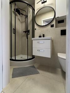 a bathroom with a shower and a sink and a mirror at Healthy Life Apartment in Warsaw +13 photos