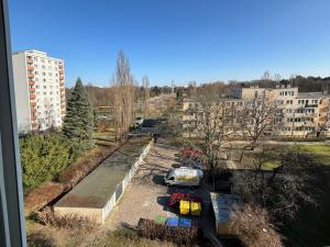 a view of a city with cars parked in a parking lot at Healthy Life Apartment in Warsaw