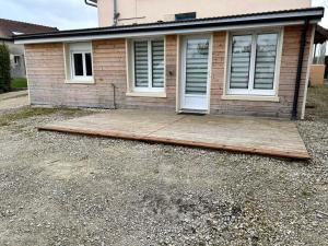 a house with a wooden deck in front of it at Appartement à Mailly-le-camp in Mailly-le-Camp
