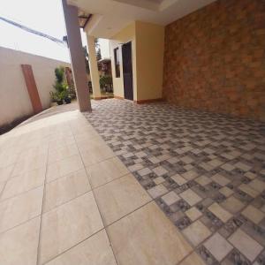 a room with a tile floor and a brick wall at Eli's Villa Cebu in Cebu City