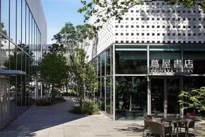 a building with a table and chairs in front of it at S2 Shibuya House 850m from Shibuya Sta in Tokyo