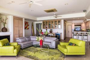 a living room with two couches and a table at Kove Villa in Honolulu