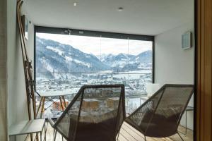 a room with a balcony with a view of the mountains at Sun Lodge Schladming by Schladming-Appartements in Schladming