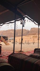 a view of a desert with mountains in the background at The life on Mars wadi rum in Wadi Rum