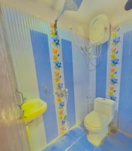 a bathroom with a toilet and a sink at Hotel Diamond inn @Esplanade in Kolkata
