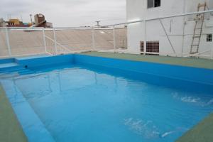 a pool of blue water on top of a building at Hotel Antonia in Termas de Río Hondo