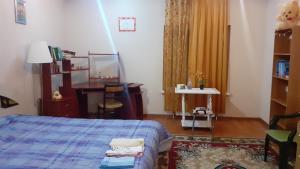 a bedroom with a bed and a table and a desk at SION In Ulmu in Ulmu