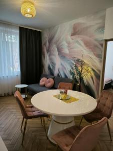 salon ze stołem i kanapą w obiekcie Apartament Dawna Mleczarnia Apartament Sosnowy w mieście Nowa Ruda