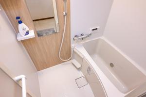 a small bathroom with a sink and a bath tub at Satorie Beppu in Beppu +84 photos
