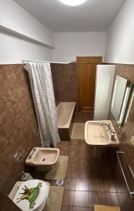 a bathroom with a sink and a toilet and a tub at Guest House Demma in Rome