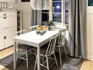 a white table and chairs in a kitchen with a window at Holiday home Gnarp II in Jättendal