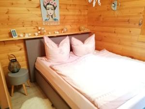 a bedroom with a bed in a wooden room at Ferienhaus Landliebe in Eschwege