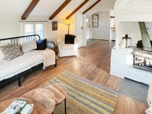 a living room with a white couch and chairs at 4 person holiday home in FÄRJESTADEN-By Traum in Färjestaden