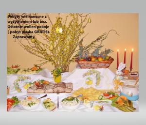 a table with food on it with lit candles at Mazurska Chata jezioro i aquapark 6 min centrum i promenada 12 min in Mikołajki