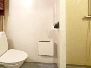 a bathroom with a white toilet in a stall at Holiday home ANNEBY in Aneby