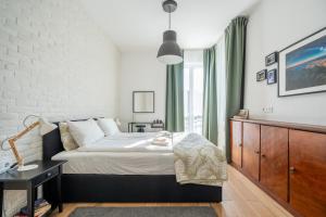 a bedroom with a bed and a large window at Elegant Getaway Near Iconic Eagles' Bridge in Sofia