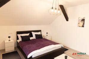 a bedroom with a bed and two night stands at Apartment Eden in Požega