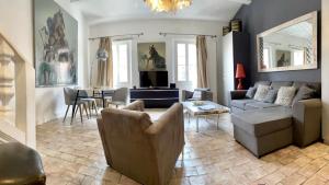 a living room with a couch and a table at Les Remparts Antibes Location in Antibes