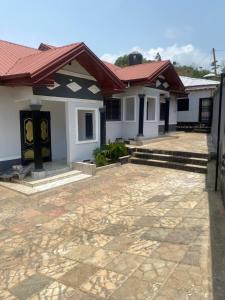 a row of white houses with red roofs at Eden Meadows Estate (Dr. John) in Limbe