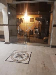 a room with a door with a mosaic on the floor at مبني الششة 5 in Al Khansāk