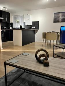 a living room with a table and a kitchen at Walnut Apartments in Brumby