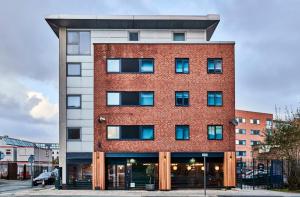 a red brick building with blue windows at For Students Only Private Ensuites with Shared Kitchen at Capital Gate in Liverpool in Liverpool