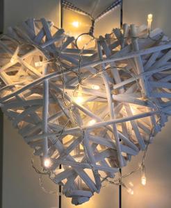 a metal heart chandelier hanging from a ceiling at Il Canneto in Lomnago +36 photos