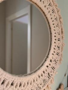 a round mirror with a knitted ring around it at Il Canneto in Lomnago