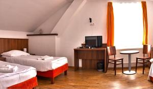 Postel nebo postele na pokoji v ubytování Hotel Kácov