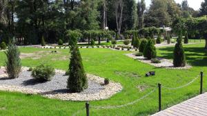 a park with bushes and trees in the grass at Apartment - Generala Petrova Street in Odesa