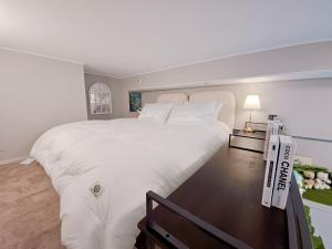 Un dormitorio con una gran cama blanca y una mesa en Hygge 722 Blue Ocean4, en Incheon