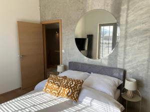 a bedroom with a bed with a mirror on the wall at Apartament ZETA - CITY 2 in Ustroń
