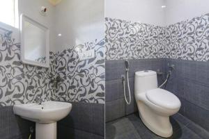 a bathroom with a sink and a toilet and a mirror at FabHotel Champion Residency in Bangalore