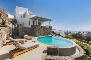 eine Villa mit einem Pool und einem Haus in der Unterkunft Breathtaking 6 Bed in Platis Gialos in Platis Gialos
